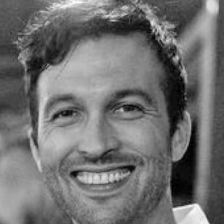 black-and-white-close-up-portrait-of-a-smiling-matt-morin-with-short-wavy-hair
